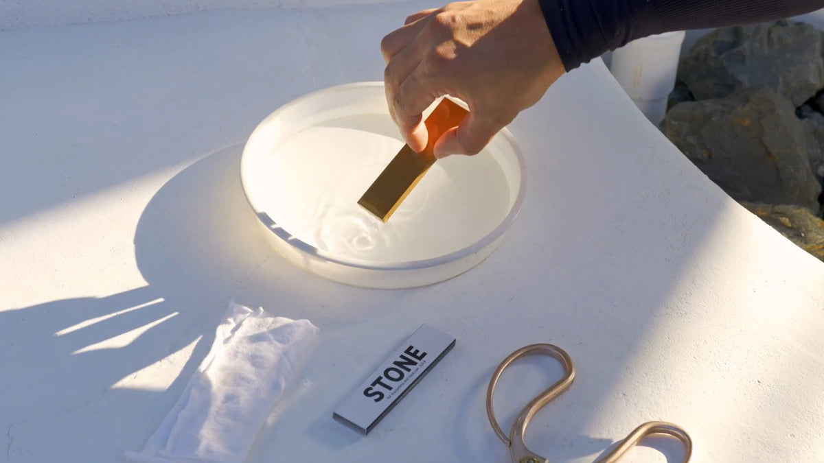 Wetting a traditional Japanese sharpening stone (whetstone).