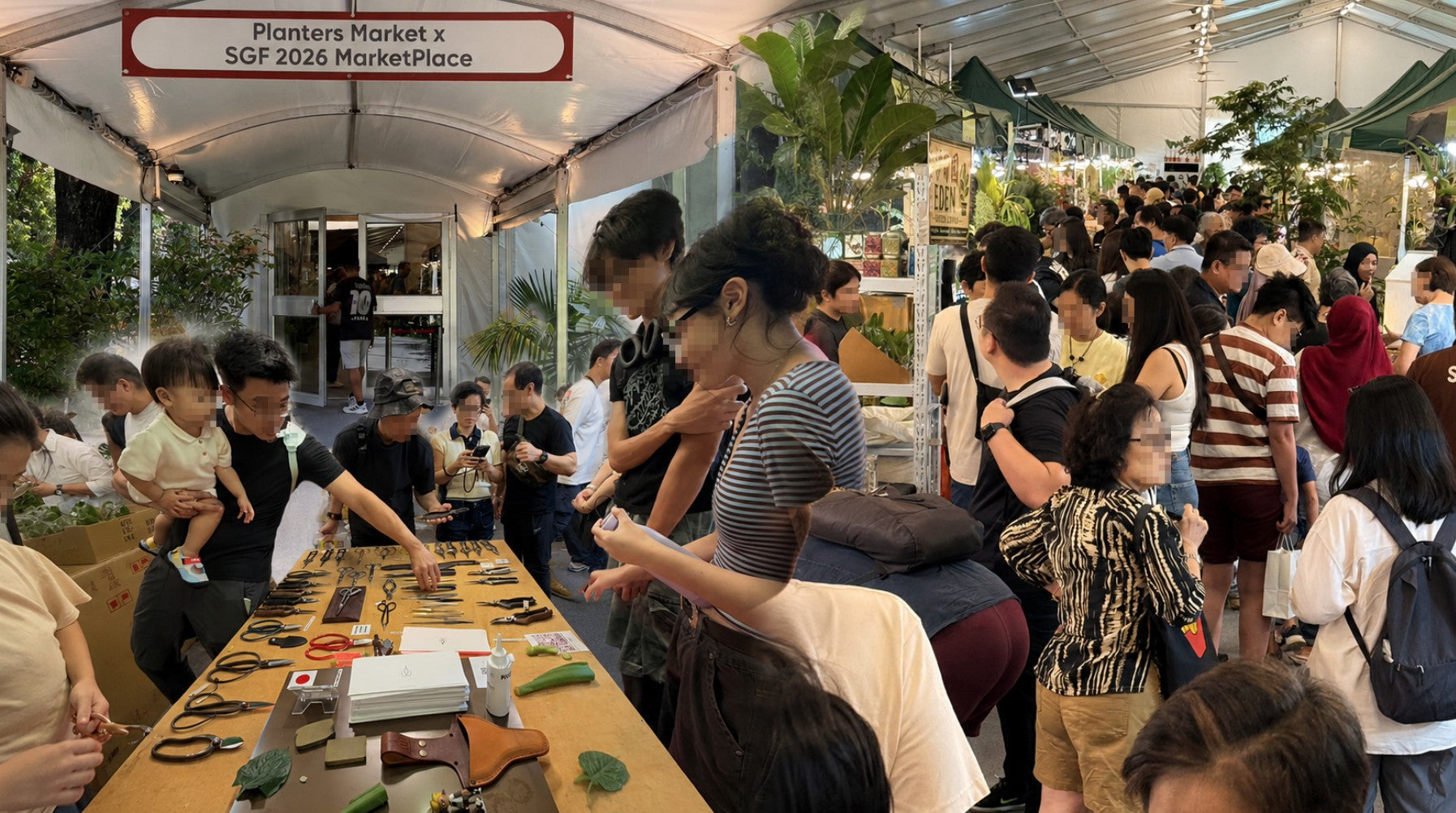 Visitors browsing Toyama Hamono pruning shears and gardening tools at the crowded Planters Market x SGF 2026 marketplace.