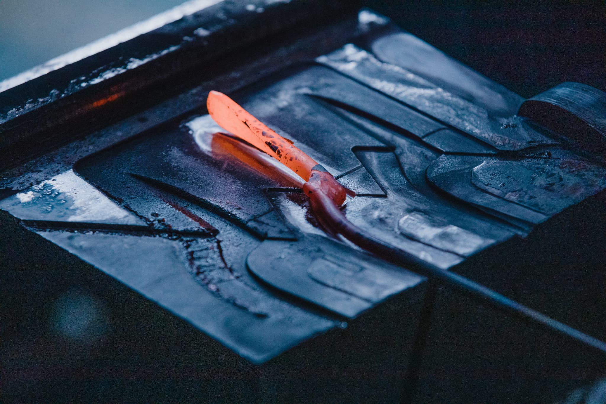 A piece of glowing steel ready for forging at Toyama Hamono.