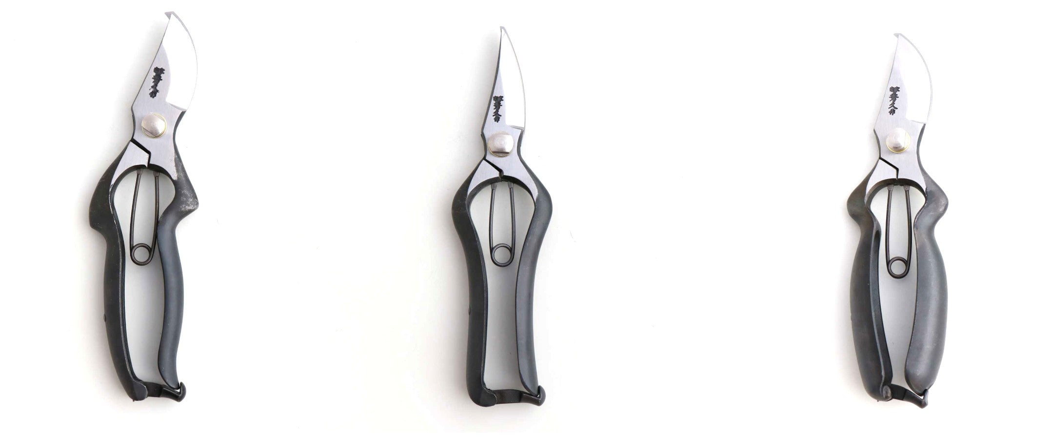 Three pairs of kitchen shears on a white background