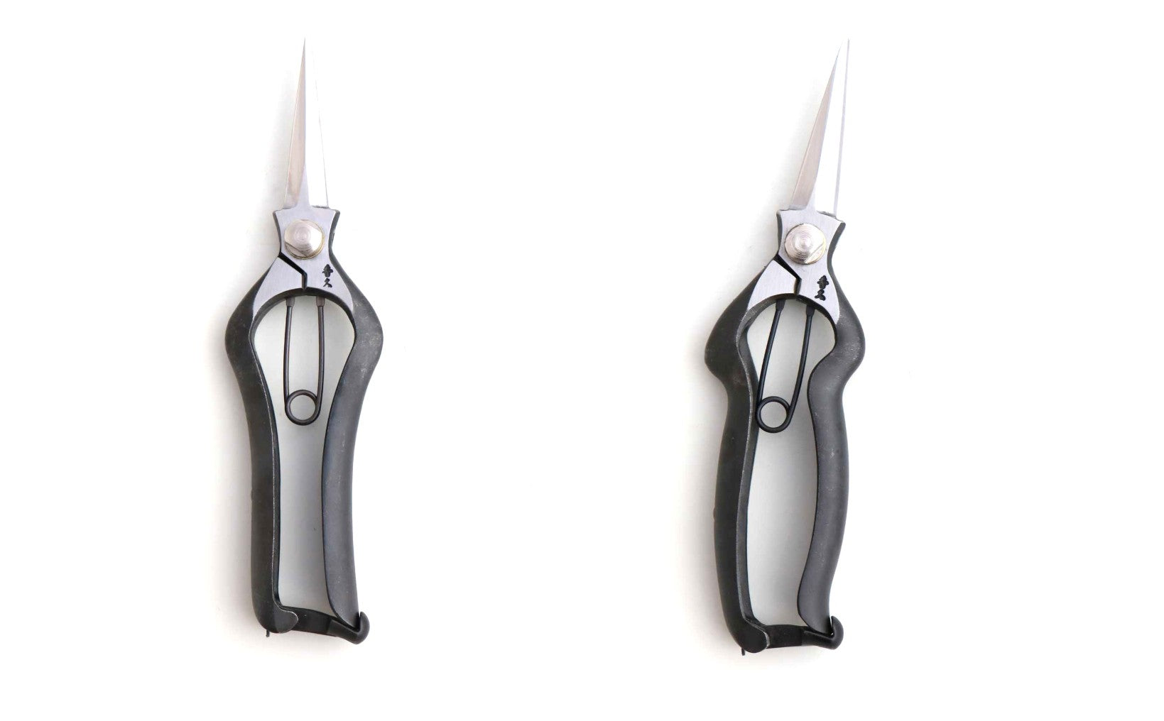 Two pairs of shears with black handles on a white background