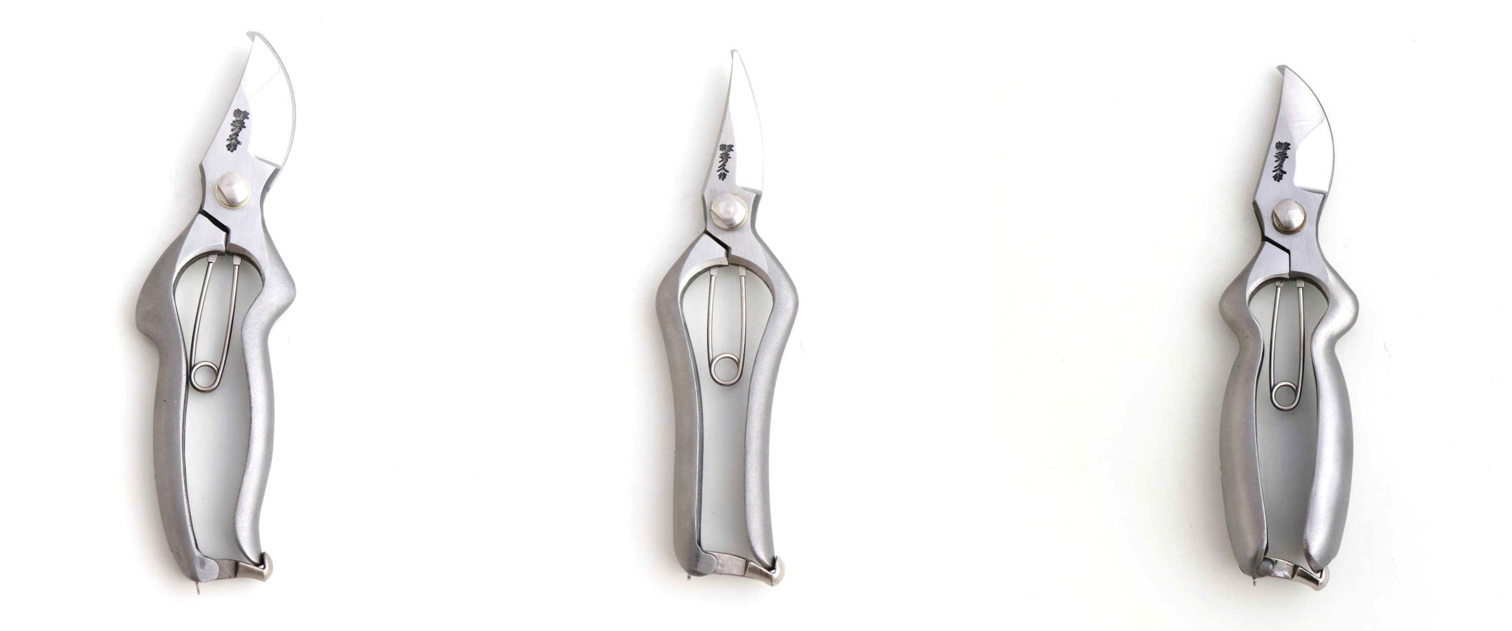 Three pairs of silver pliers on a white background